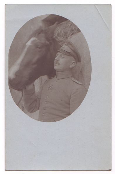 A 'head and shoulders' portrait taken with the officer's horse looking over his shoulder.
