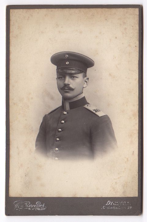 A formal, head and shoulders portrait of a young officer.