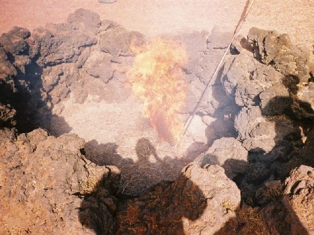 Dry brush set on fire by the heat of the rock below the surface.