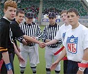 Team captains shake hands before the game, Panthers to right.